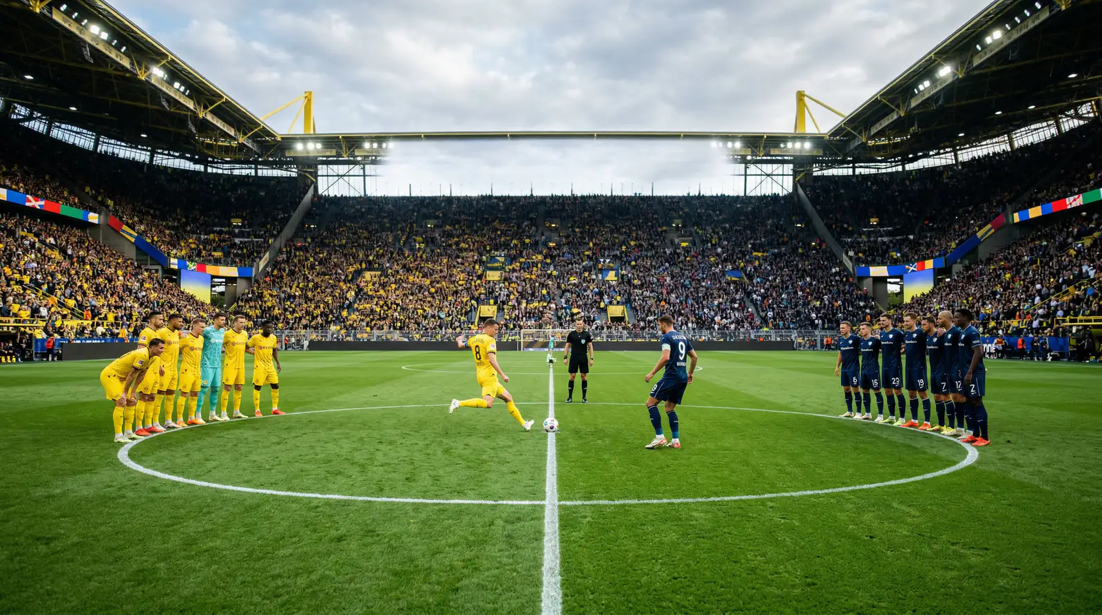 Zwei Fußballmannschaften beim Anstoß auf dem Spielfeld im vollen Stadion